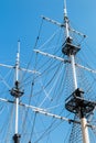 The mast of a sailboat against a blue sky