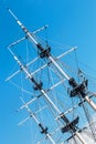 The mast of a sailboat against a blue sky
