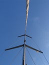 The mast of a sailing ship with its sails furled Royalty Free Stock Photo