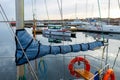 The mast of a sailing yacht, sail ropes and a folded sail. Blue sea background. Safety, safe traveling concept. Sea Royalty Free Stock Photo