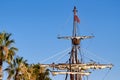 Mast of the spanish replica of the Nao de Santa Maria with some palm trees
