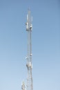Mast or tower for mobile phone communication in bright sunshine and blue sky. Relay tower internet 4G