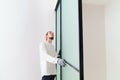 master adjusts sliding doors of wardrobe made of metal and glass. Royalty Free Stock Photo