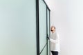 master adjusts sliding doors of wardrobe made of metal and glass. Royalty Free Stock Photo