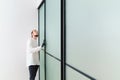 master adjusts sliding doors of wardrobe made of metal and glass. Royalty Free Stock Photo