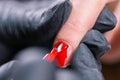 Master applied varnish drawing on nails gel in manicure salon, close-up. Gel polish concept.