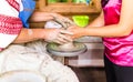 Master and apprentice learning clay crafting, potter and woman hands