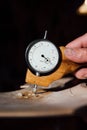 Master artisan luthier working on the creation of a violin. painstaking detailed work on wood.