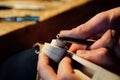 Master artisan luthier working on the creation of a violin. painstaking detailed work on wood.