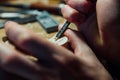 Master artisan luthier working on the creation of a violin. painstaking detailed work on wood.