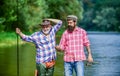 Master baiter. Mature man with friend fishing. Summer vacation. Happy cheerful people. Fisherman with fishing rod Royalty Free Stock Photo