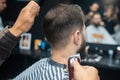 Master in barbershop makes men& x27;s haircutting with hair clipper Royalty Free Stock Photo