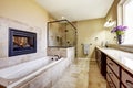 Master bathroom in modern house with fireplace and tile floor Royalty Free Stock Photo