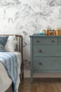 Master Bedroom with Blue Dresser and Floral Wallpaper