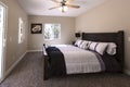Master bedroom with dark carpet and bed made San Diego California Royalty Free Stock Photo