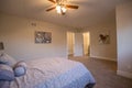 Master bedroom with fan and bed spread Royalty Free Stock Photo