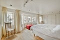 the master bedroom has a large bed and a window Royalty Free Stock Photo