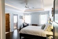 Master bedroom with king size bed and tray ceilings with uplighting and hradwood floors Royalty Free Stock Photo