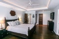 Master bedroom with king size bed and tray ceilings with uplighting and hradwood floors