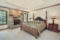 Master bedroom with stone fireplace Royalty Free Stock Photo