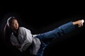 TaeKwonDo Karate teenager athlete kick punch black background isolated