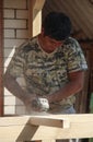 The master carpenter polishes the boards. Construction of the terrace and woodwork.