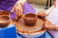 Master ceramist teaches student.Master ceramist teaches student. Craftsman hands making pottery bowl. Woman working on potter