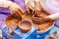 Master ceramist teaches student.Master ceramist teaches student. Craftsman hands making pottery bowl. Woman working on potter