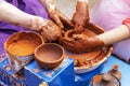 Master ceramist teaches student.Master ceramist teaches student. Craftsman hands making pottery bowl. Woman working on potter Royalty Free Stock Photo