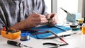 Master Checking Microchip Board In Repairs Workshop