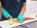 Master chef butcher is dissecting part of meat tenderloin , slicing membrane. Royalty Free Stock Photo