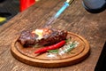 Master chef cooking barbecue Beef Grilled steak meat with fire flames on wooden table