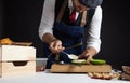 Cook preparing burger adding the sauce on green bun. Royalty Free Stock Photo