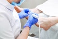 Master chiropody shapes the nails . Male patient in the process of hardware pedicure procedure. Concept body care. Close up, selec Royalty Free Stock Photo