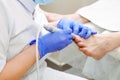 Master chiropody shapes the nails . Male patient in the process of hardware pedicure procedure. Concept body care. Close up, selec Royalty Free Stock Photo