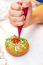 Master class with children on coloring gingerbread icing.