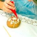 Master class with children on coloring gingerbread icing.