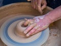 Master class on modeling of clay on a potter`s wheel In the pottery workshop for children sunny day