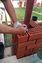 The master at the construction site is laying a brick laying Royalty Free Stock Photo