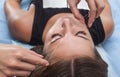 Master corrects makeup, gives shape and thread plucks eyebrows in a beauty salon.