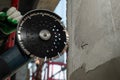 Master cuts a concrete wall with a circular diamond saw.