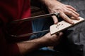 The master cuts out a stand for strings with a hand fretsaw Royalty Free Stock Photo