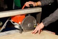 A worker cuts porcelain tiles on an industrial tile cutter with a diamond blade Royalty Free Stock Photo