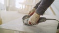 The master cuts the tiles on an angle grinder with a special diamond disc. Cutting large ceramic tiles. The worker cuts Royalty Free Stock Photo