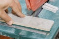 Master cuts the tiles on the saw. repair of apartments and houses. Royalty Free Stock Photo