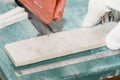 Master cuts the tiles on the saw. repair of apartments and houses. Royalty Free Stock Photo