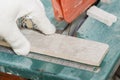 Master cuts the tiles on the saw. repair of apartments and houses. Royalty Free Stock Photo