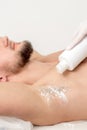 Master depilation pouring talcum powder on armpit