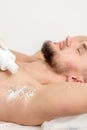 Master depilation pouring talcum powder on armpit