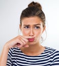 The master of disguise. a beautiful young woman using her finger to make a moustache.